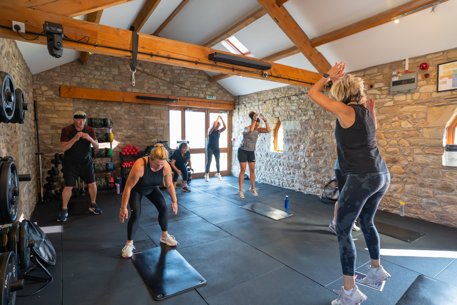 A mixed group class mid workout inside the barn