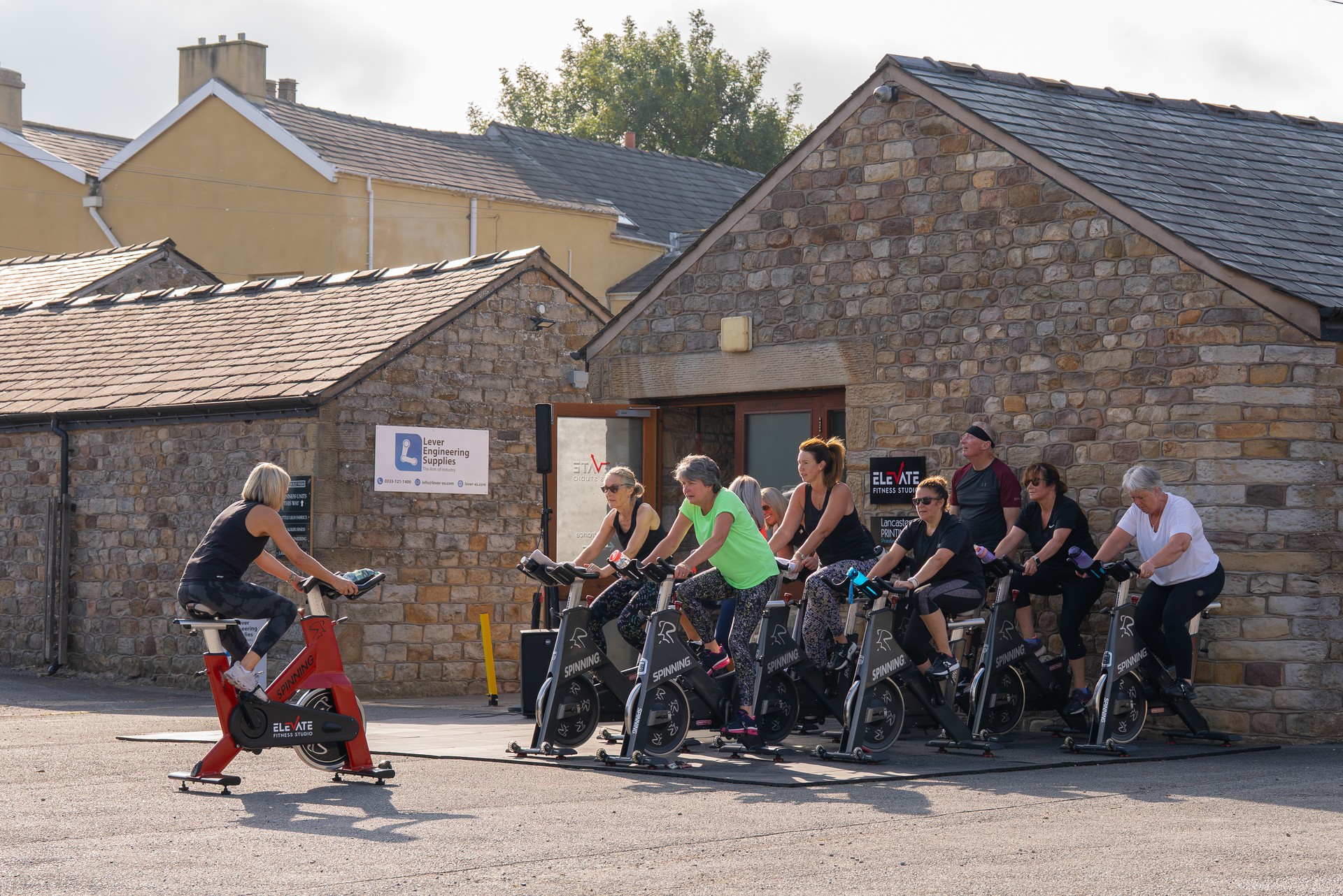 A spin class set up outside the barn